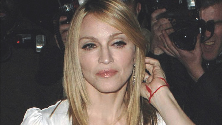 Famous musician Madonna, is known as a longtime Kabbalah follower showing her red string to ward off bad omens